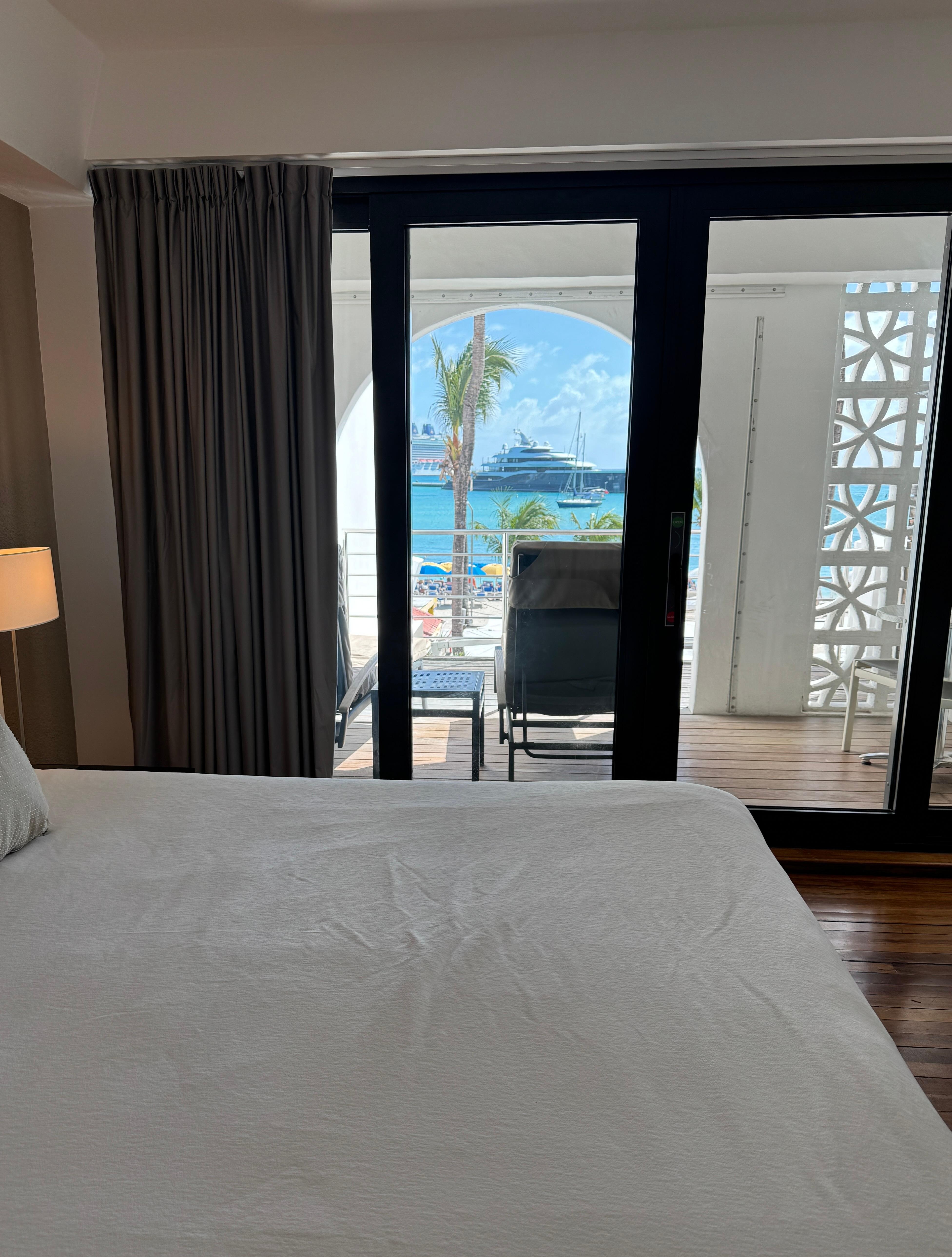Hotel room with balcony and view of beach . 
