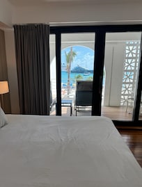 Hotel room with balcony and view of beach .
