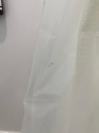 stained shower curtain with brown stains