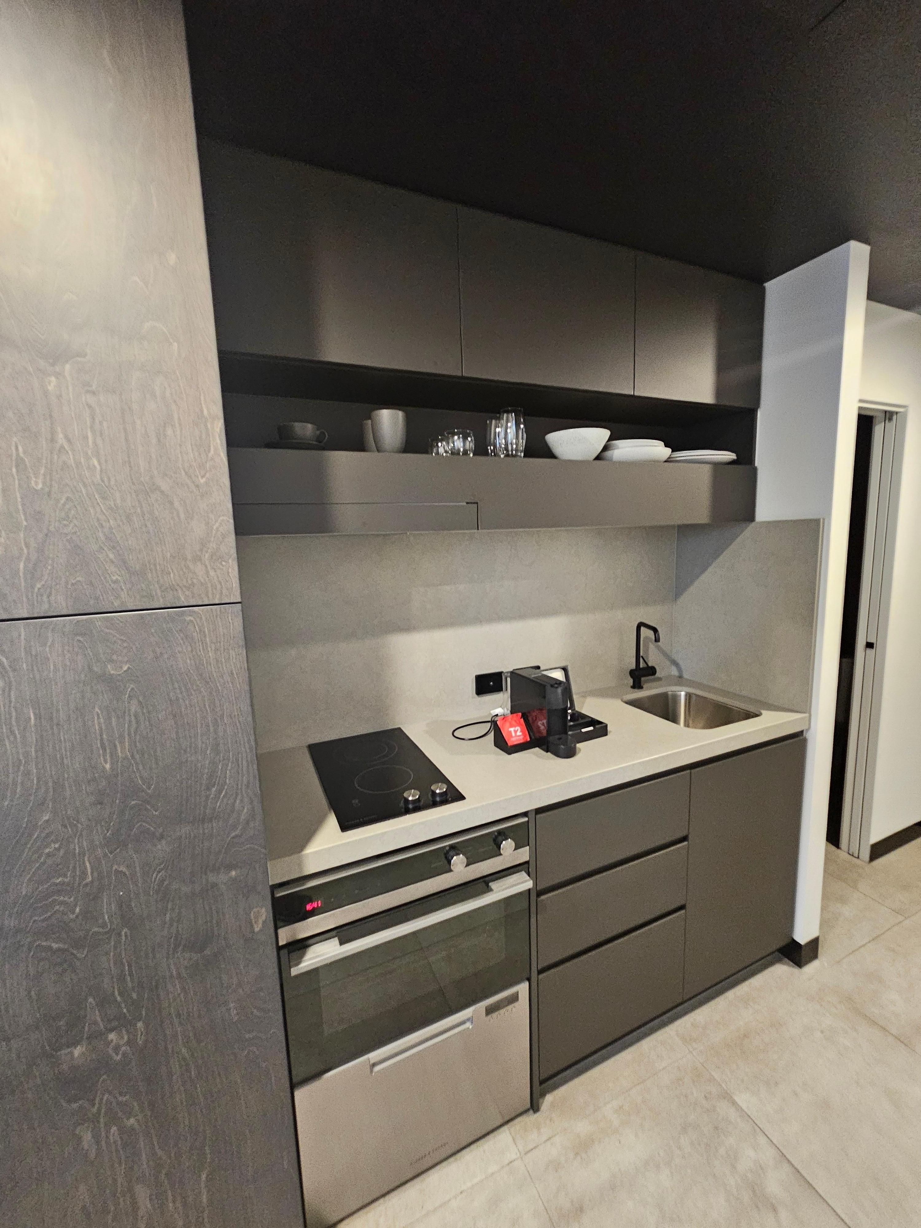 Kitchenette with frig, oven and sink.