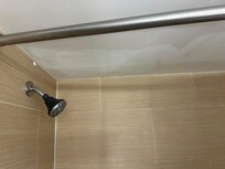 Leaking shower head . Patched ceiling