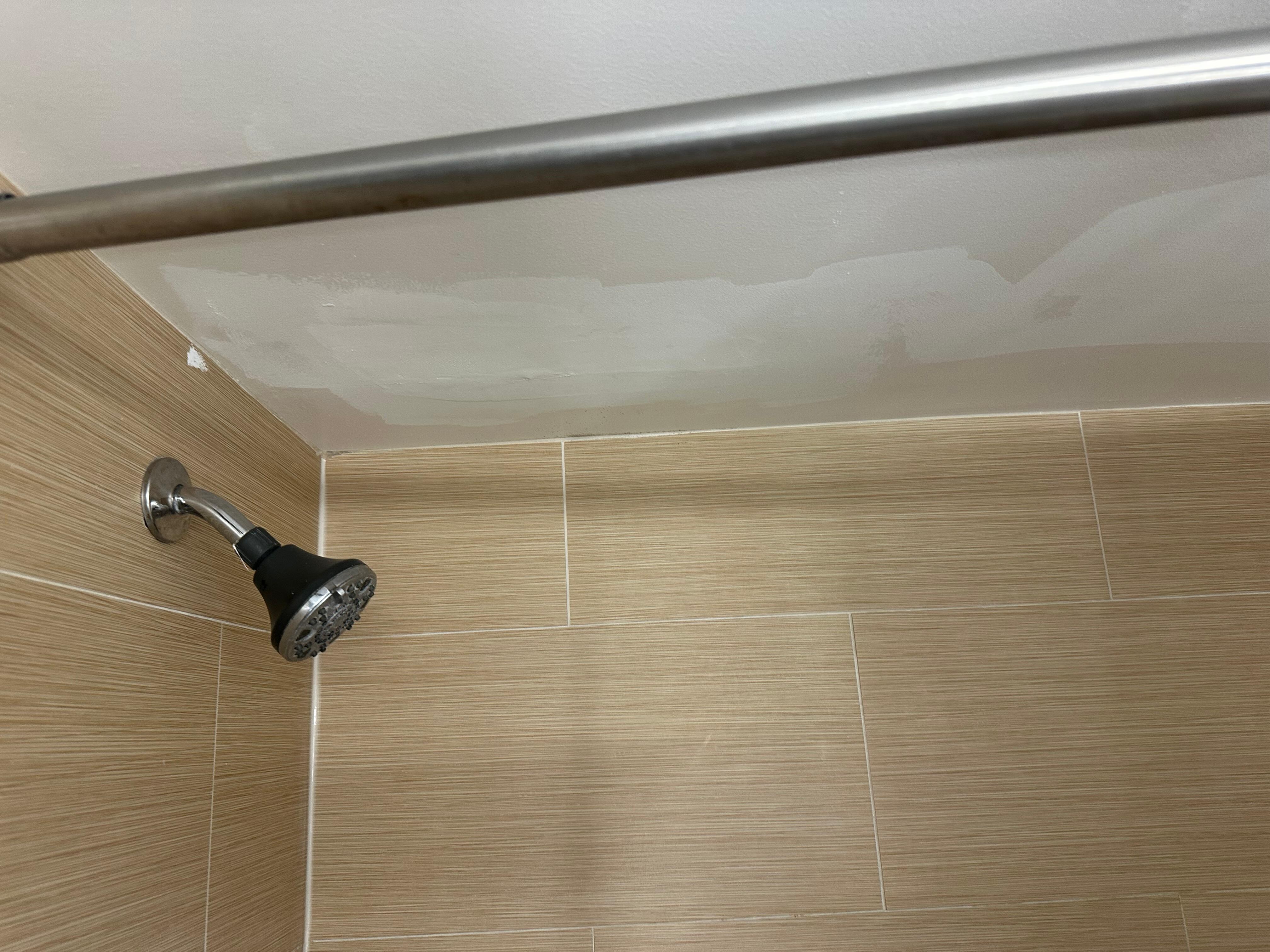 Leaking shower head . Patched ceiling 