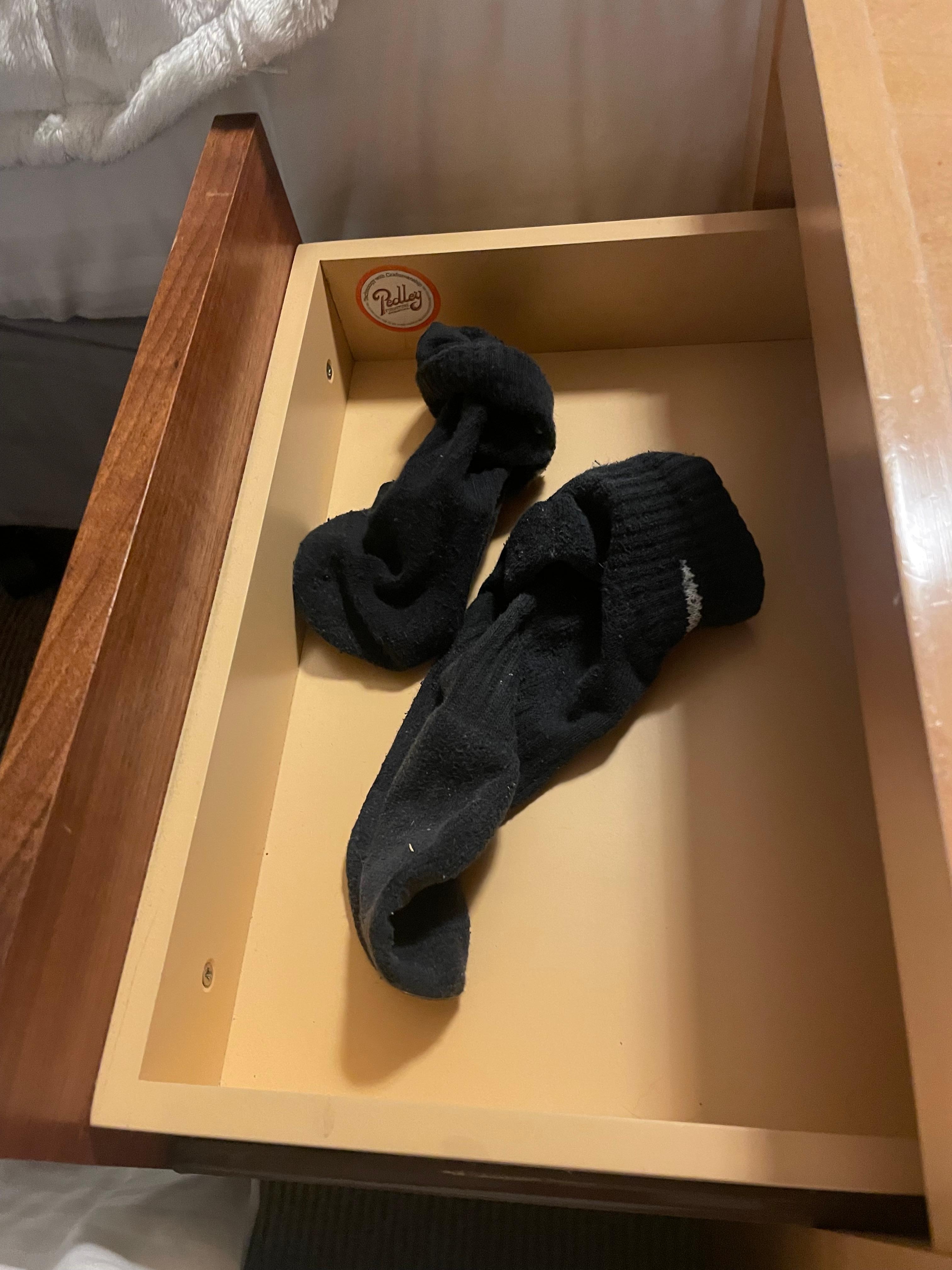 Dirty socks found in drawer next to bedside 