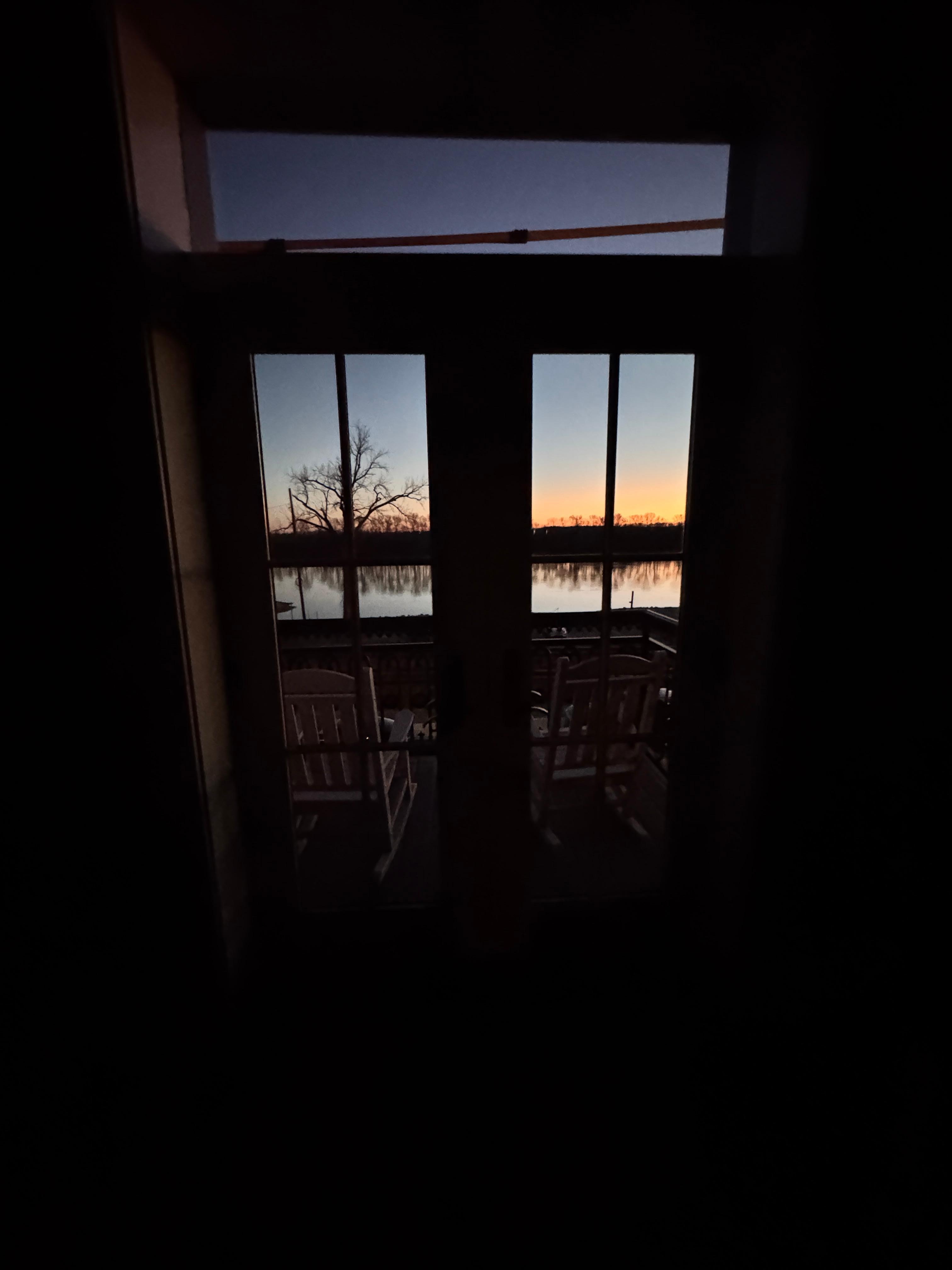 Double doors off the small deck at sunrise. 