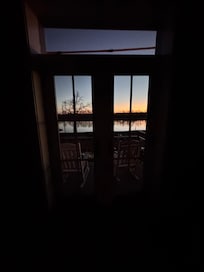 Double doors off the small deck at sunrise.