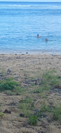 Children swimming in front of house