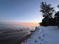 Lake and beach with sunset sky