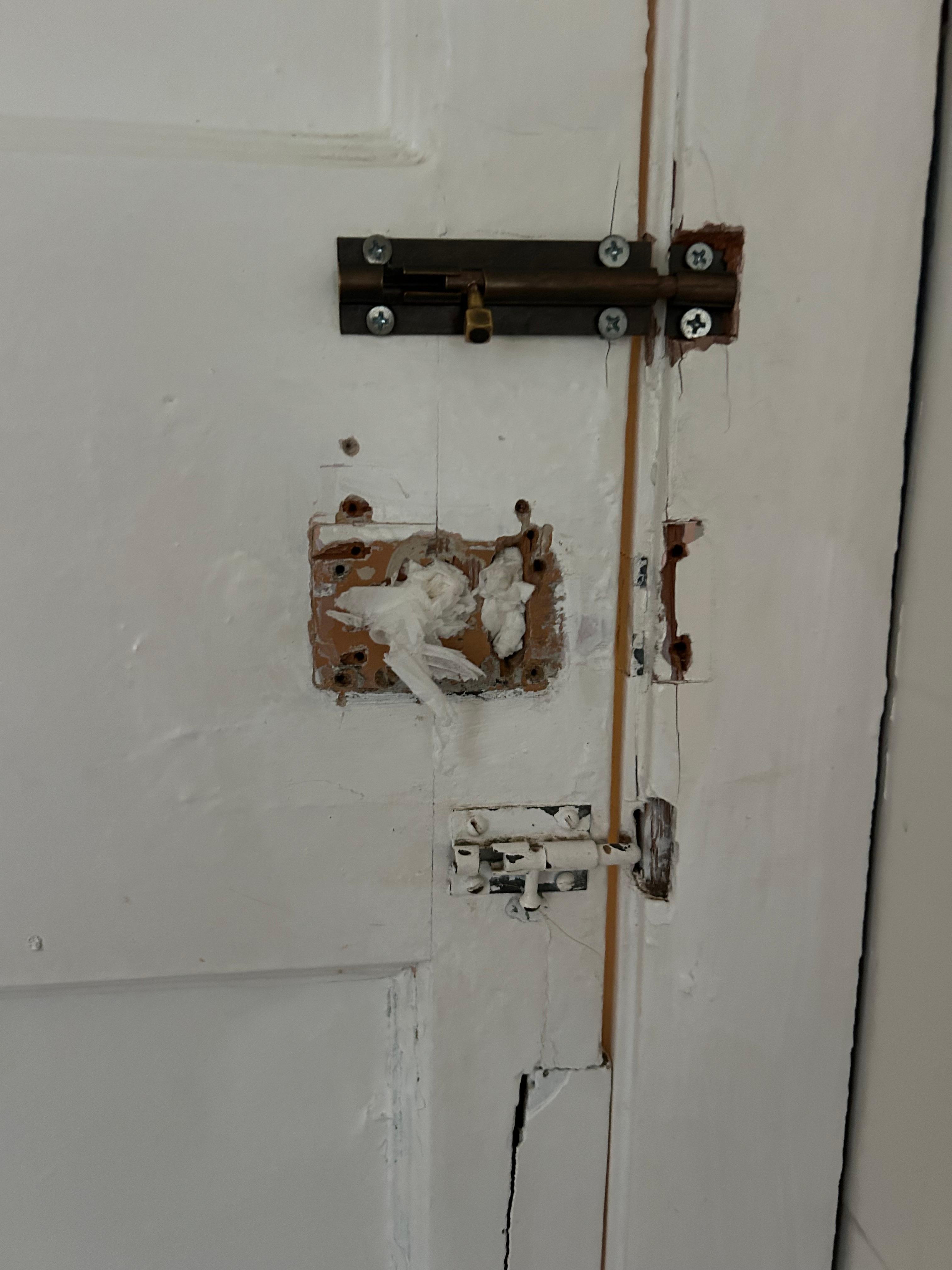 Back off toilet door  holes filled with toilet paper and bit smelly 