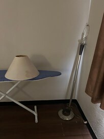 Lamp shade off sitting on the ironing board appeared to be broken.