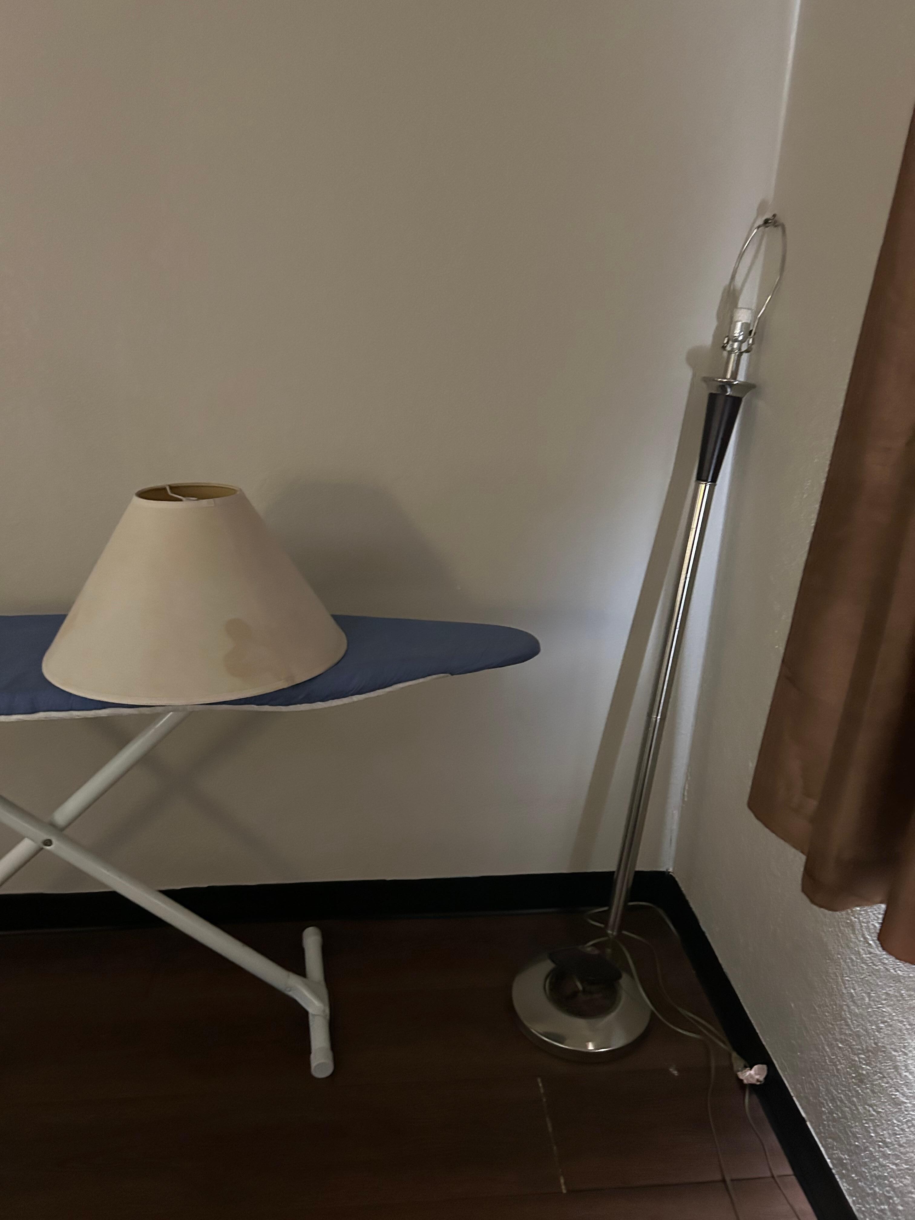 Lamp shade off sitting on the ironing board appeared to be broken.