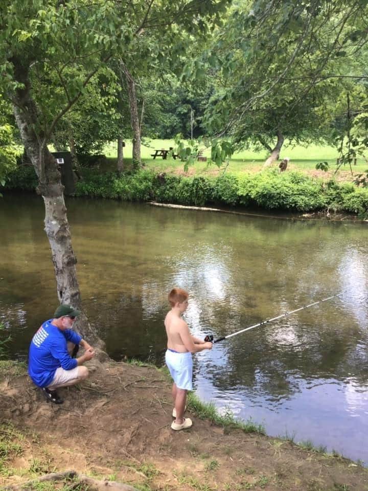 Fishing in the river behind the house. 