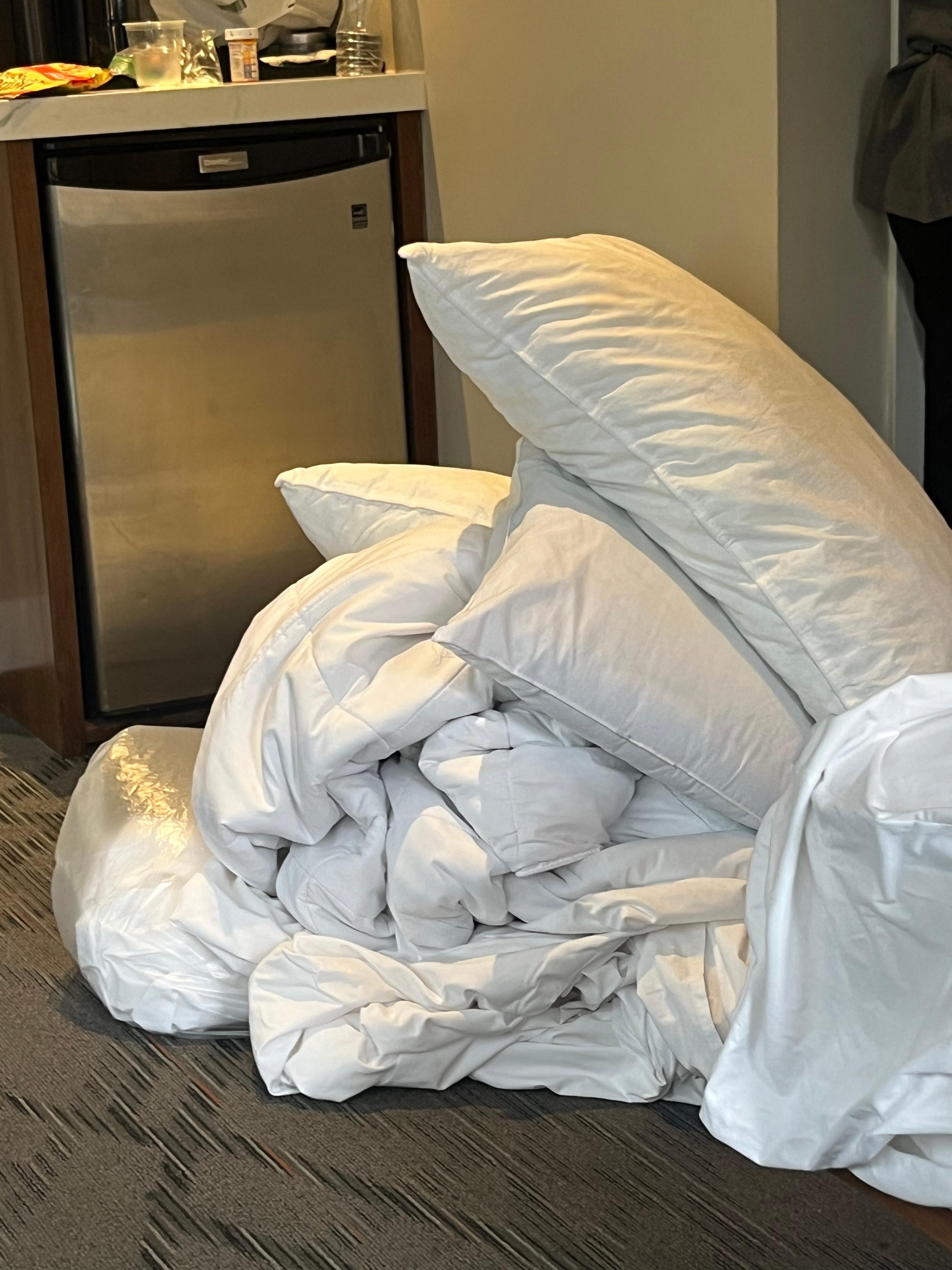 dirty bedding taken off bed