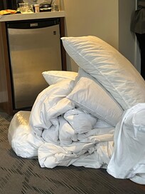 dirty bedding taken off bed