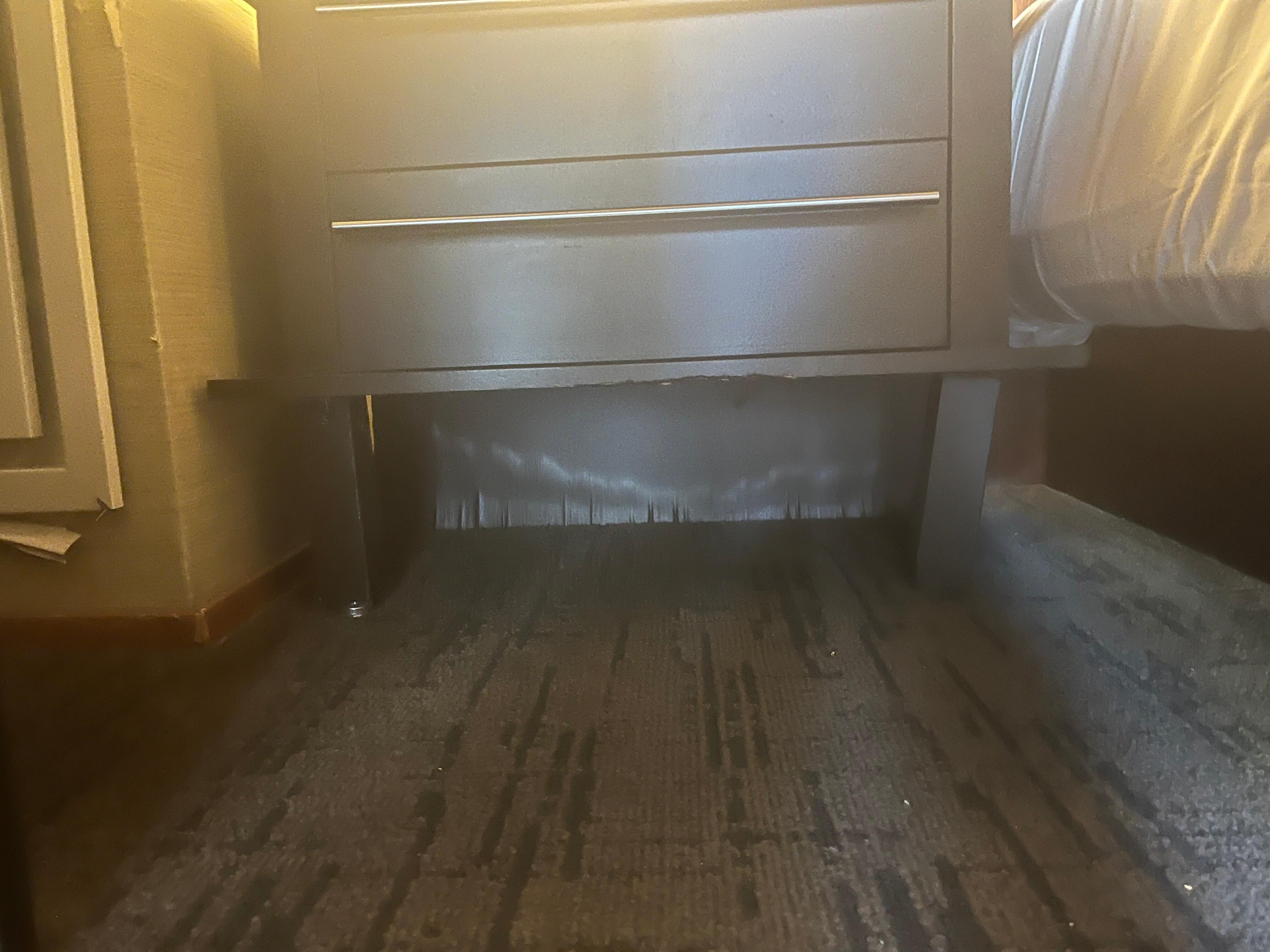 Clear water damage on the wall and leg broken on side table. Bottom of table is damaged.