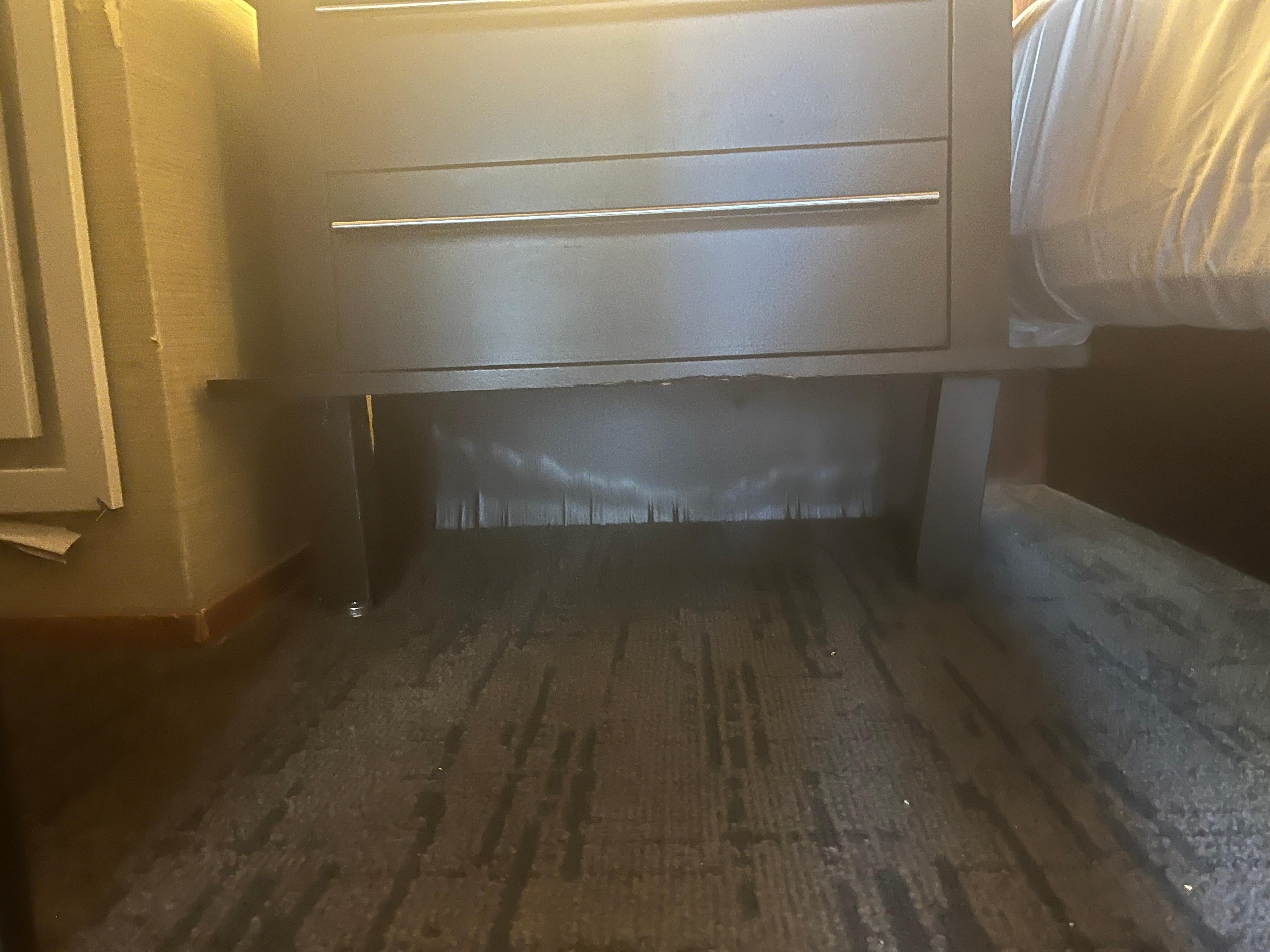 Clear water damage on the wall and leg broken on side table. Bottom of table is damaged.