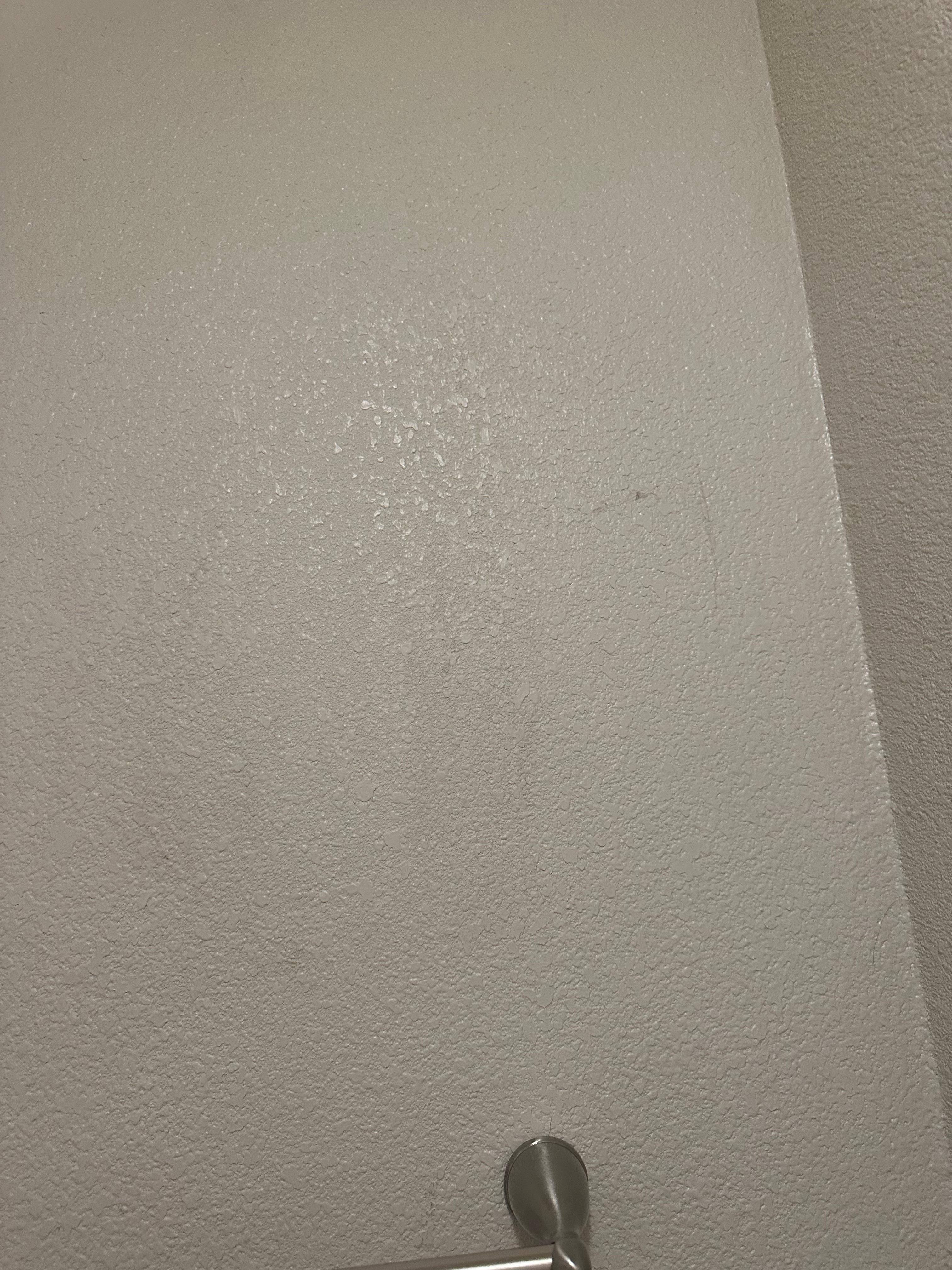 Dirty hand prints on bathroom wall