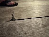 Broken and dangerous living room floor trip hazard