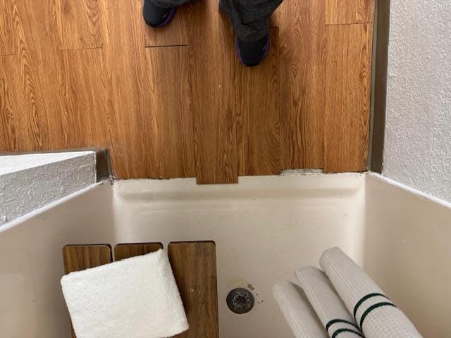 No edging to prevent shower water from getting under the flooring in the bathroom