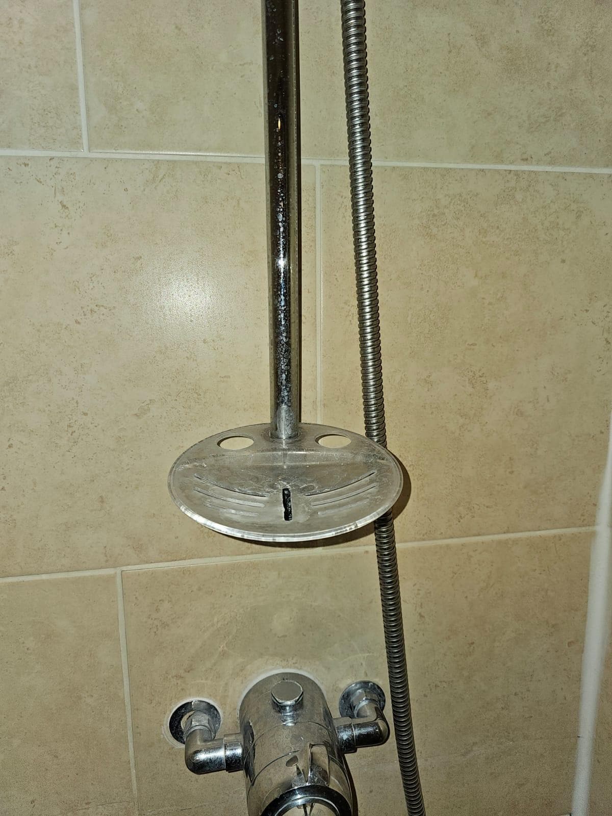 Shower soap tray with deposits dirt on it