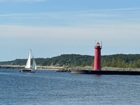 Muskegon lighthouse with incoming sailboat