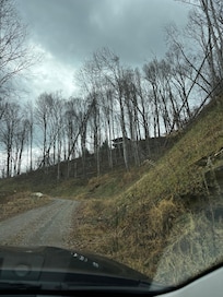 Going up the road to the tent in the trees.