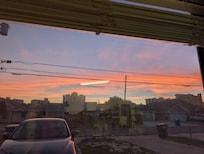 View of amazing sunset and yard from front window. Can watch sunset from couch in living room!