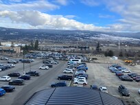 View of the secure car park and the airport across the highway with a shuttle