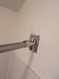 The shower curtain rod was held up by tape!!!