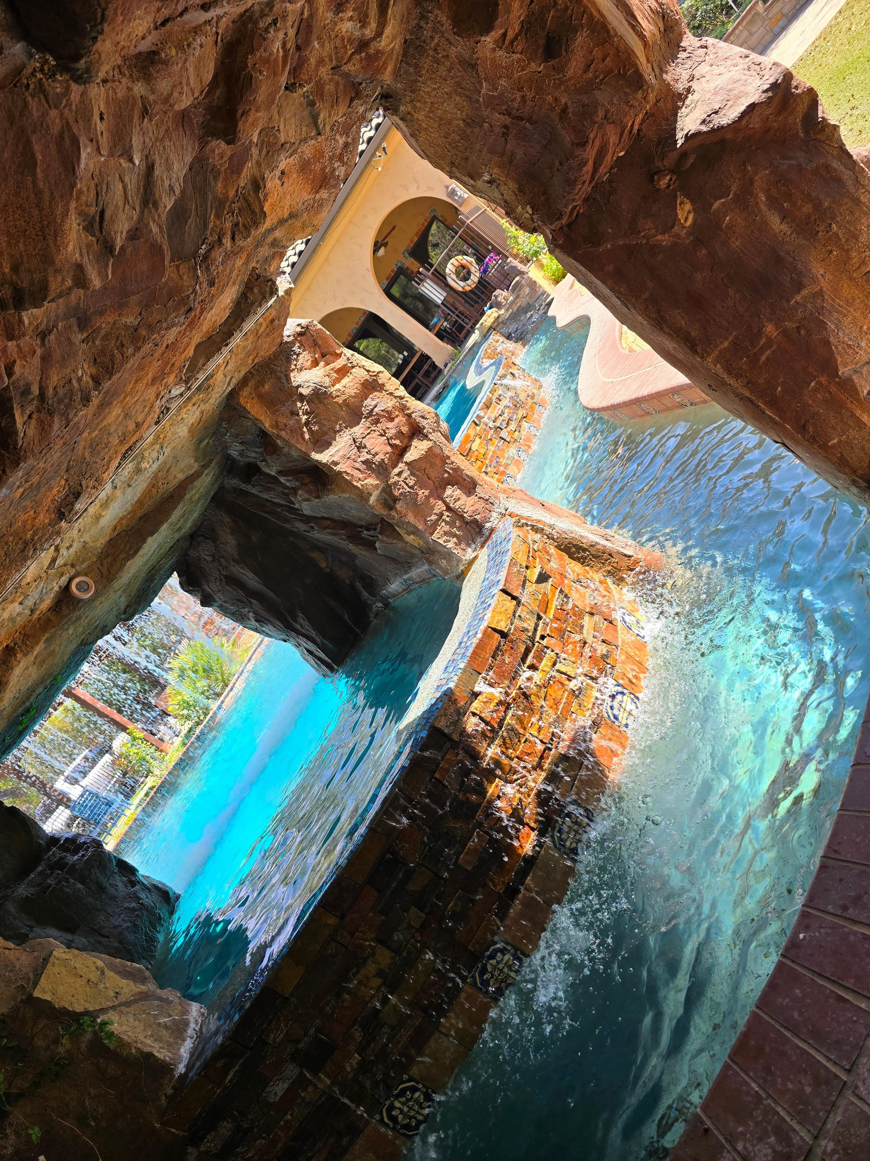 Inside the grotto are the pool/spa/light controls but the best is a full circle seating area behind the waterfall. Swim in and take a break from the sun ;)