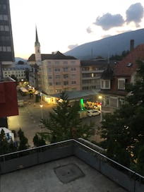 Village center view, big supermarket downstairs, and wonderful church bells chime the time.