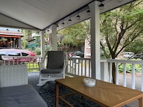 View into neighborhood from porch during morning coffee. Privacy provided by some larger trees/shrubs around side of porch.