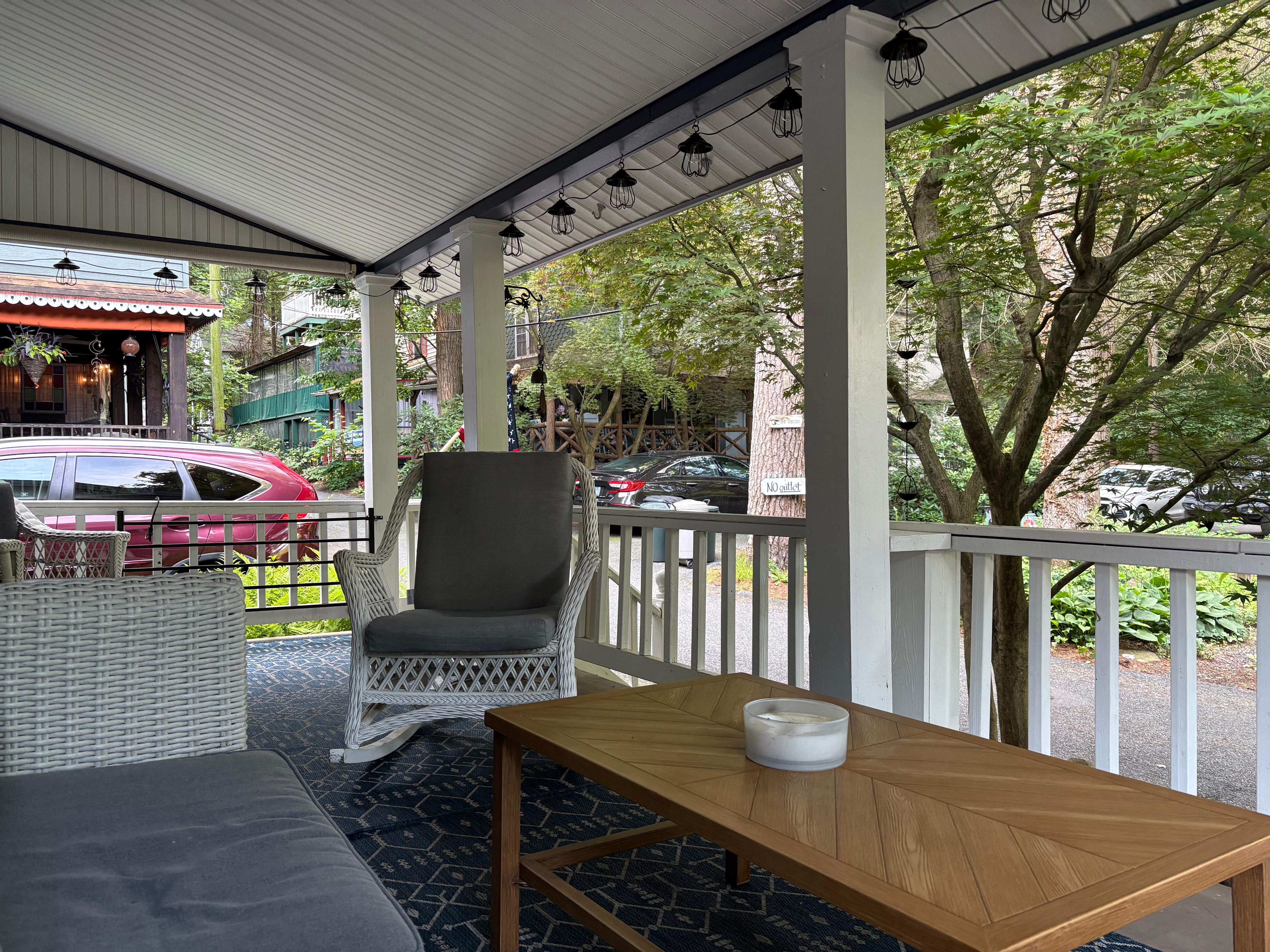 View into neighborhood from porch during morning coffee.  Privacy provided by some larger trees/shrubs around side of porch.