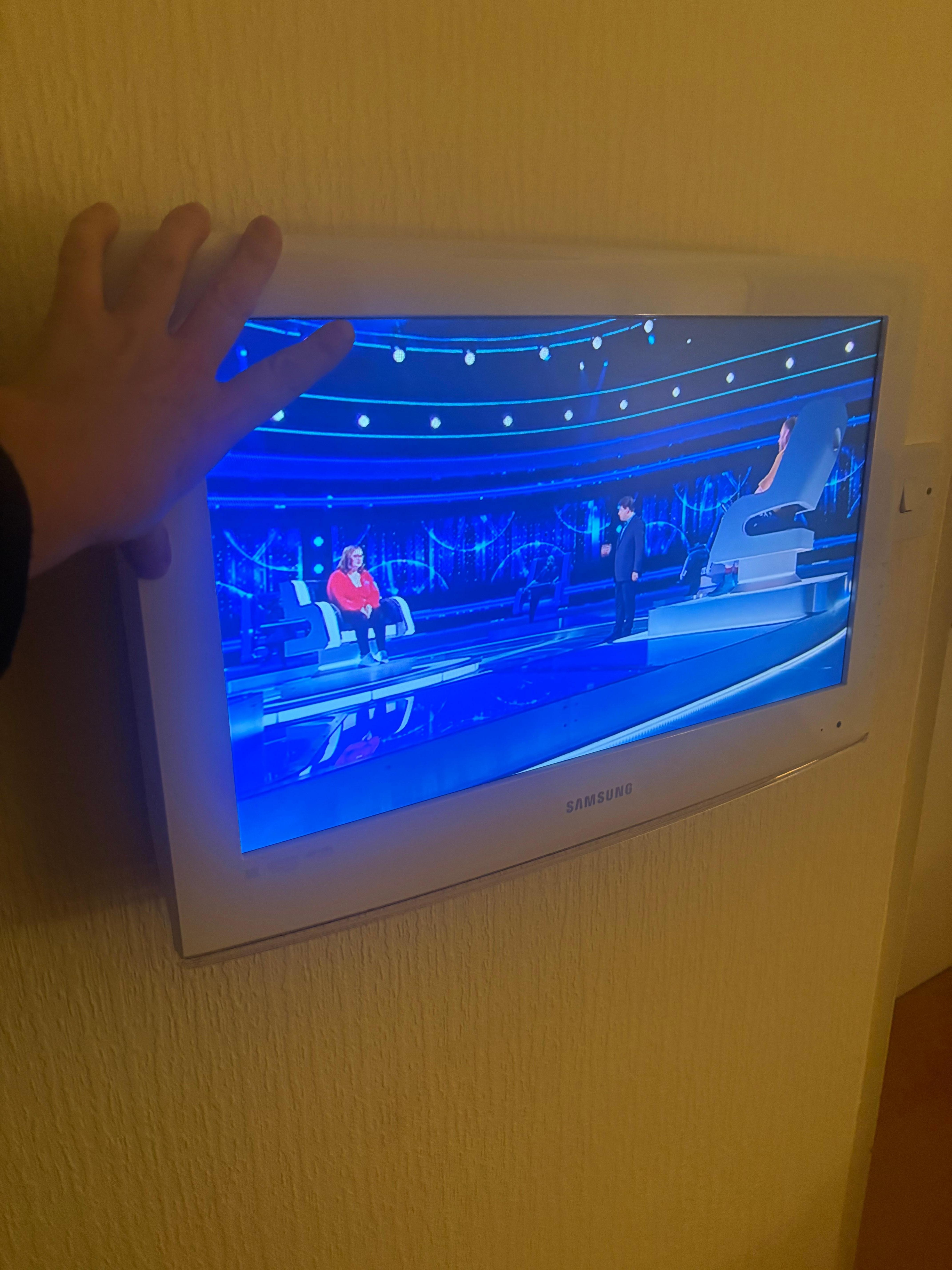 Tv on a wall that cannot be seen from the bed