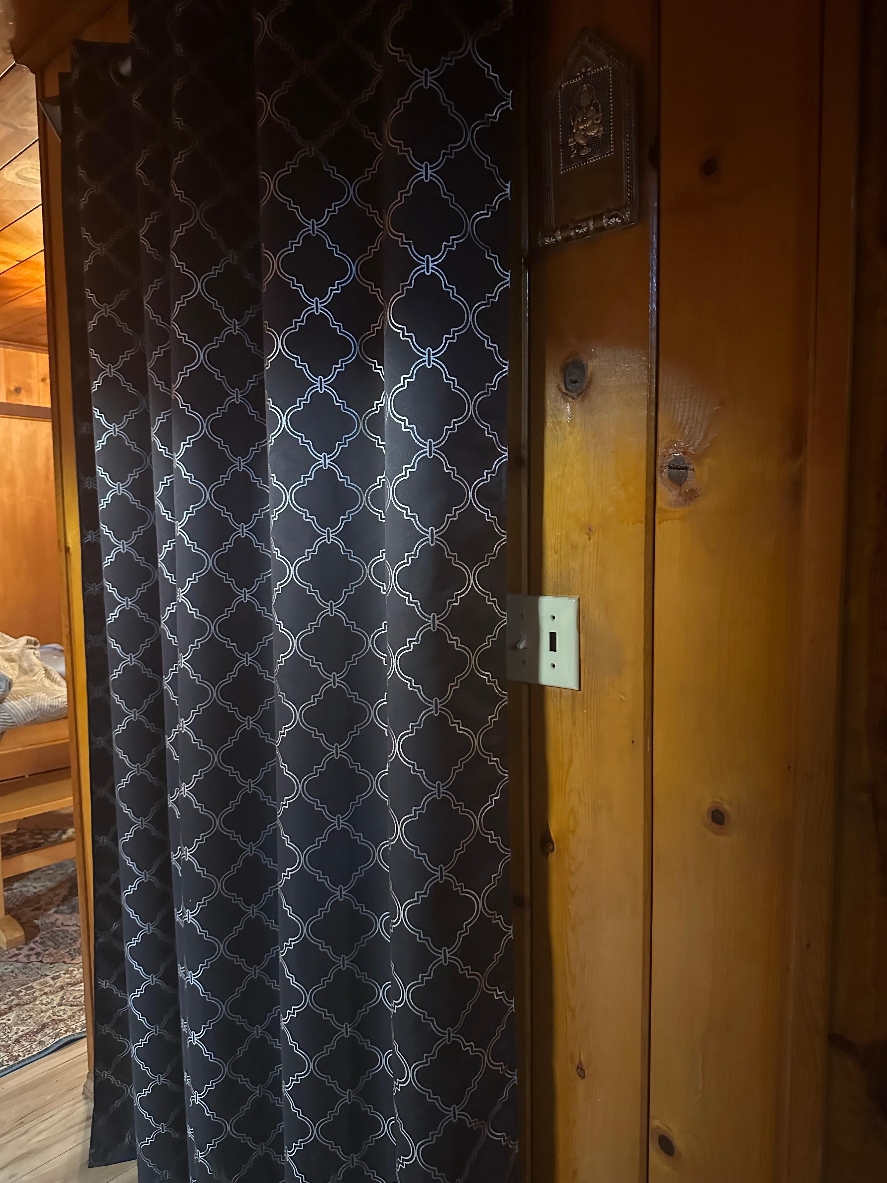 To the left is the bedroom, with no door. Just a bed in a room in front of the kitchen 