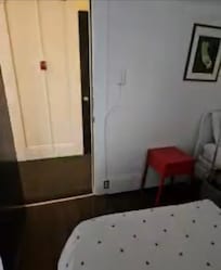 View from room to hallway with shared bathroom