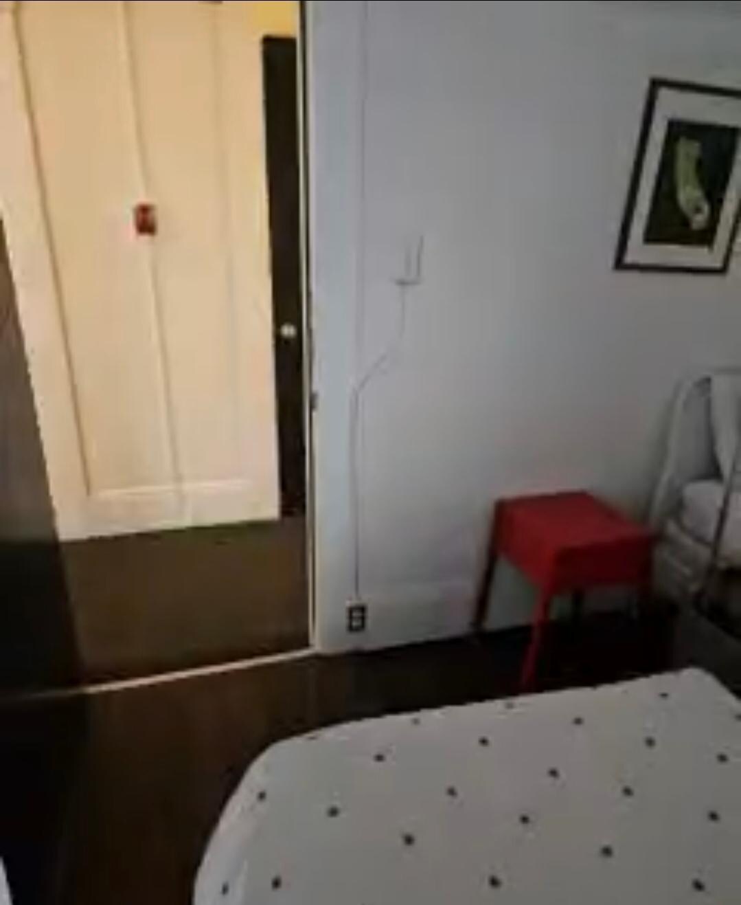View from room to hallway with shared bathroom 