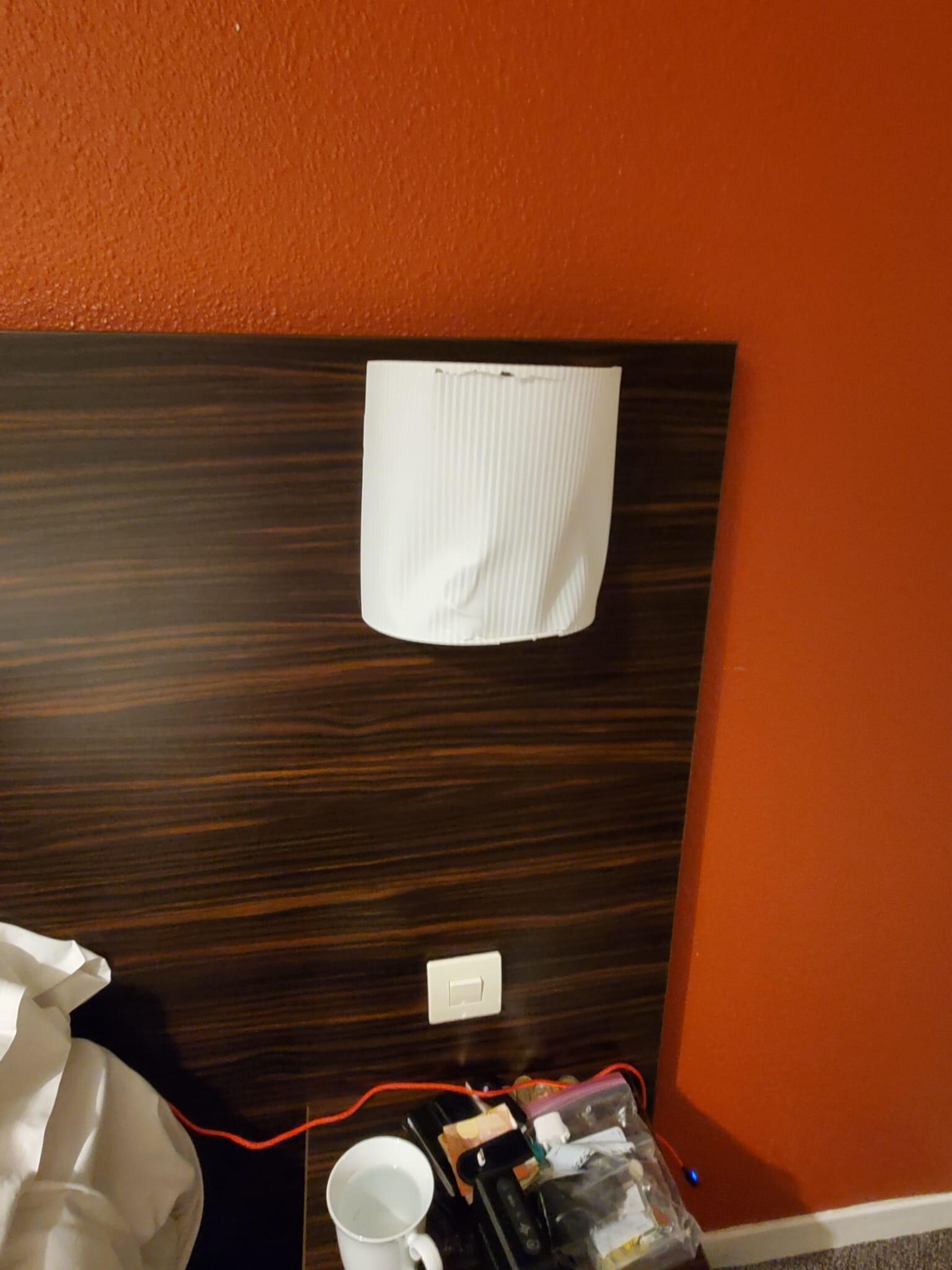 Cheap damaged sconces by the bed