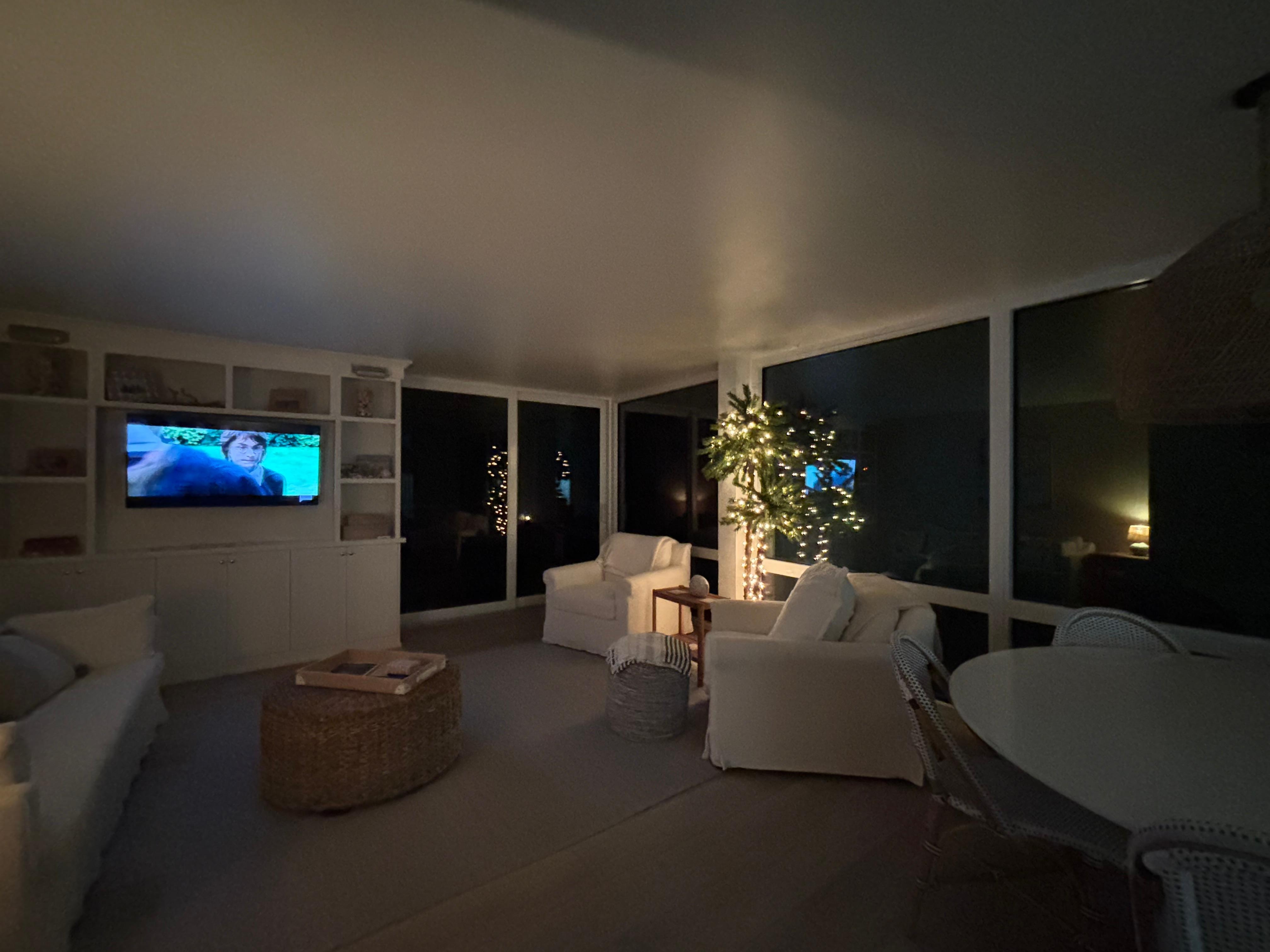 Large cozy living room area with wall of windows to porch