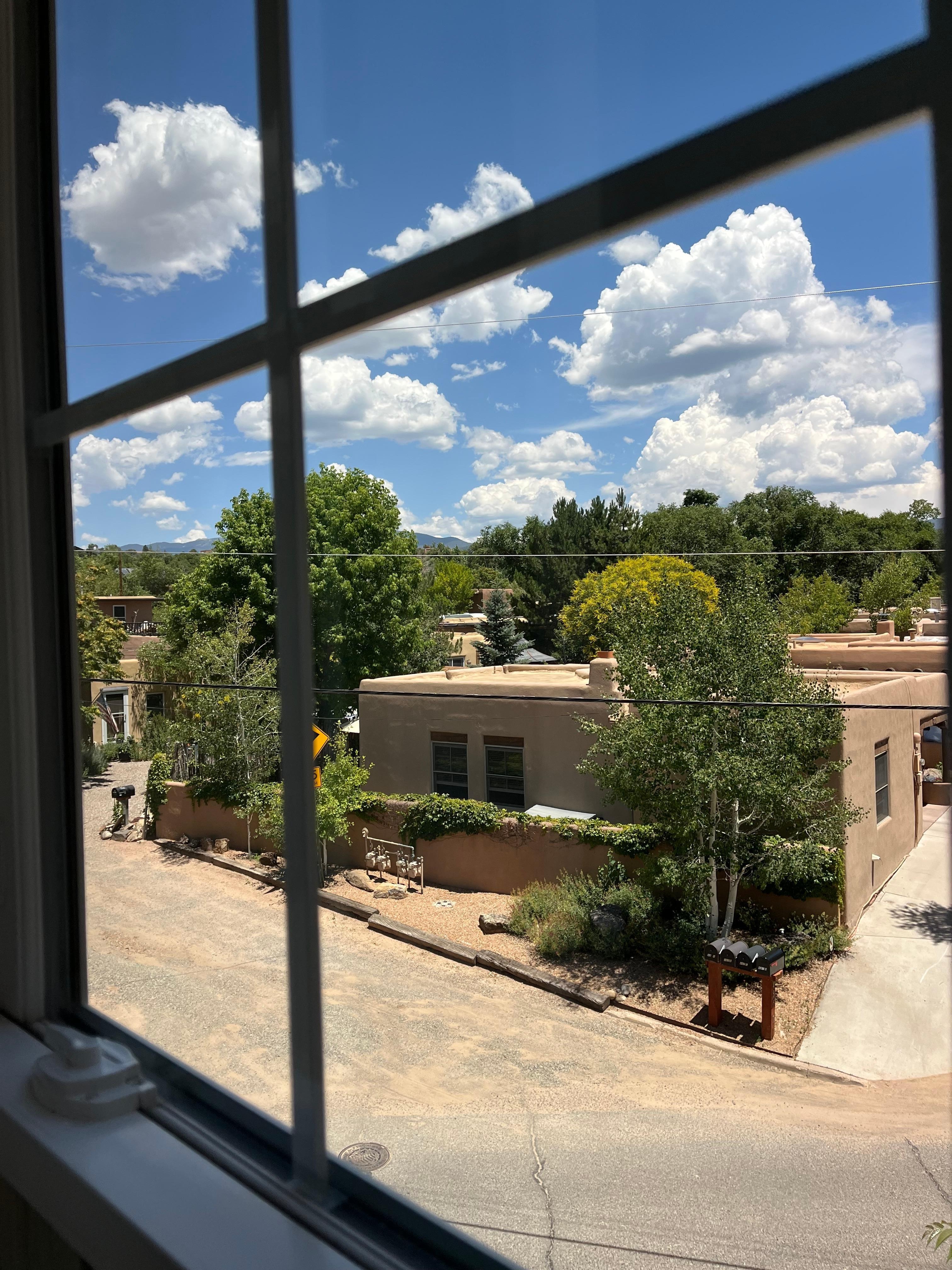 View out of the living room window, on a quiet neighborhood.