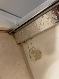 a lot of cracked, chipped paint in the bathroom and on bath tub