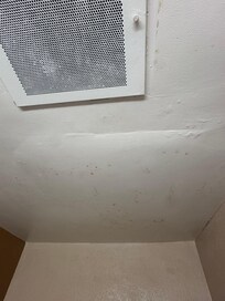 Unidentified stain on bathroom ceiling. And apparent mold in corner