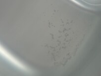 Sediment at the bottom of the hot tub and hazy dirty water.