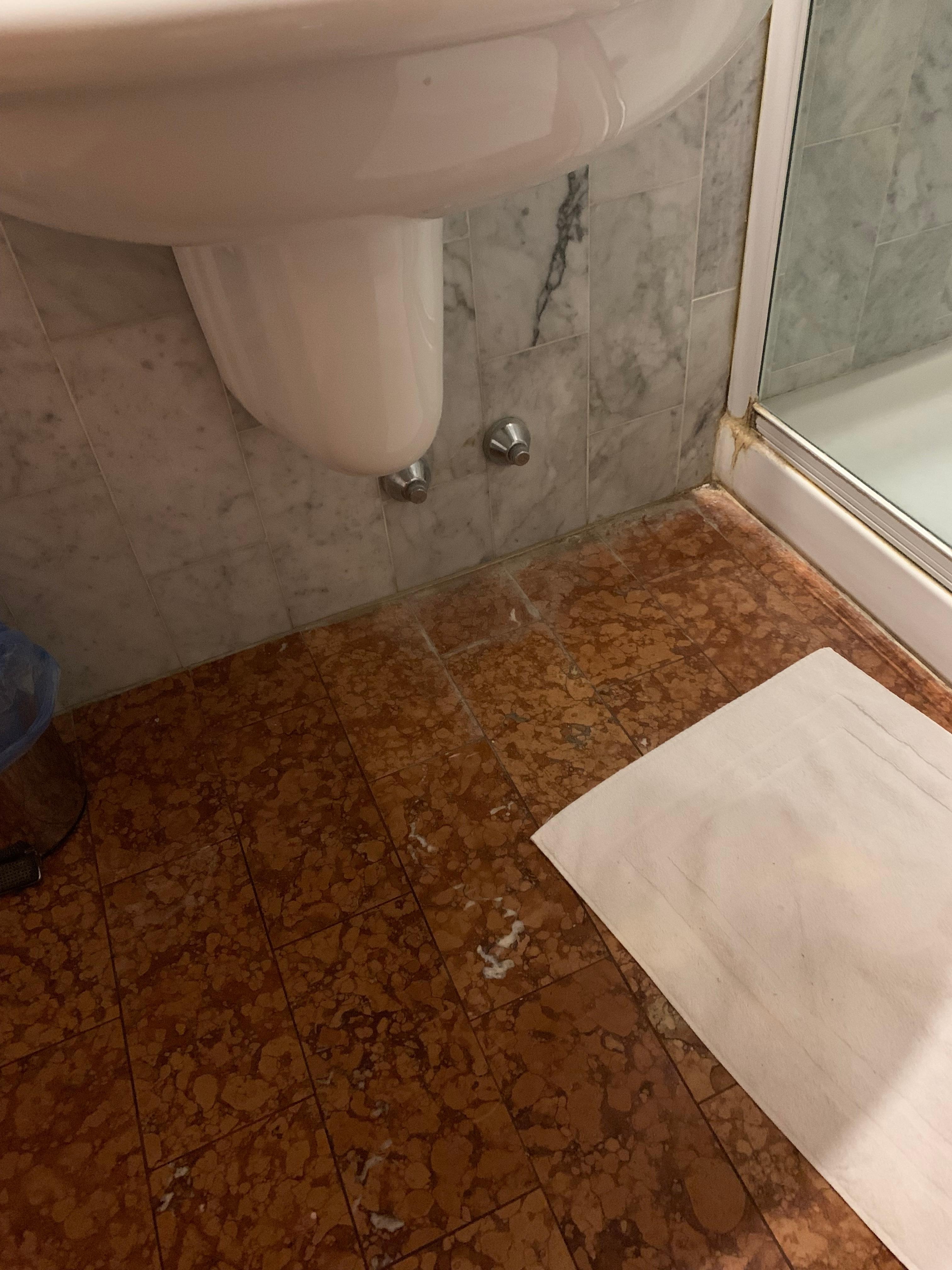 Nasty and moldy bathroom with a towel rail that was heating the room in the 35C heatwave. No vents in the bathroom. 