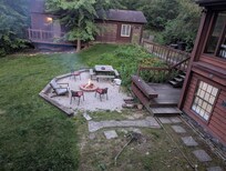 View of fire pit and garage from main building deck