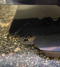 Tv stand broken with left over food crumbs under it.