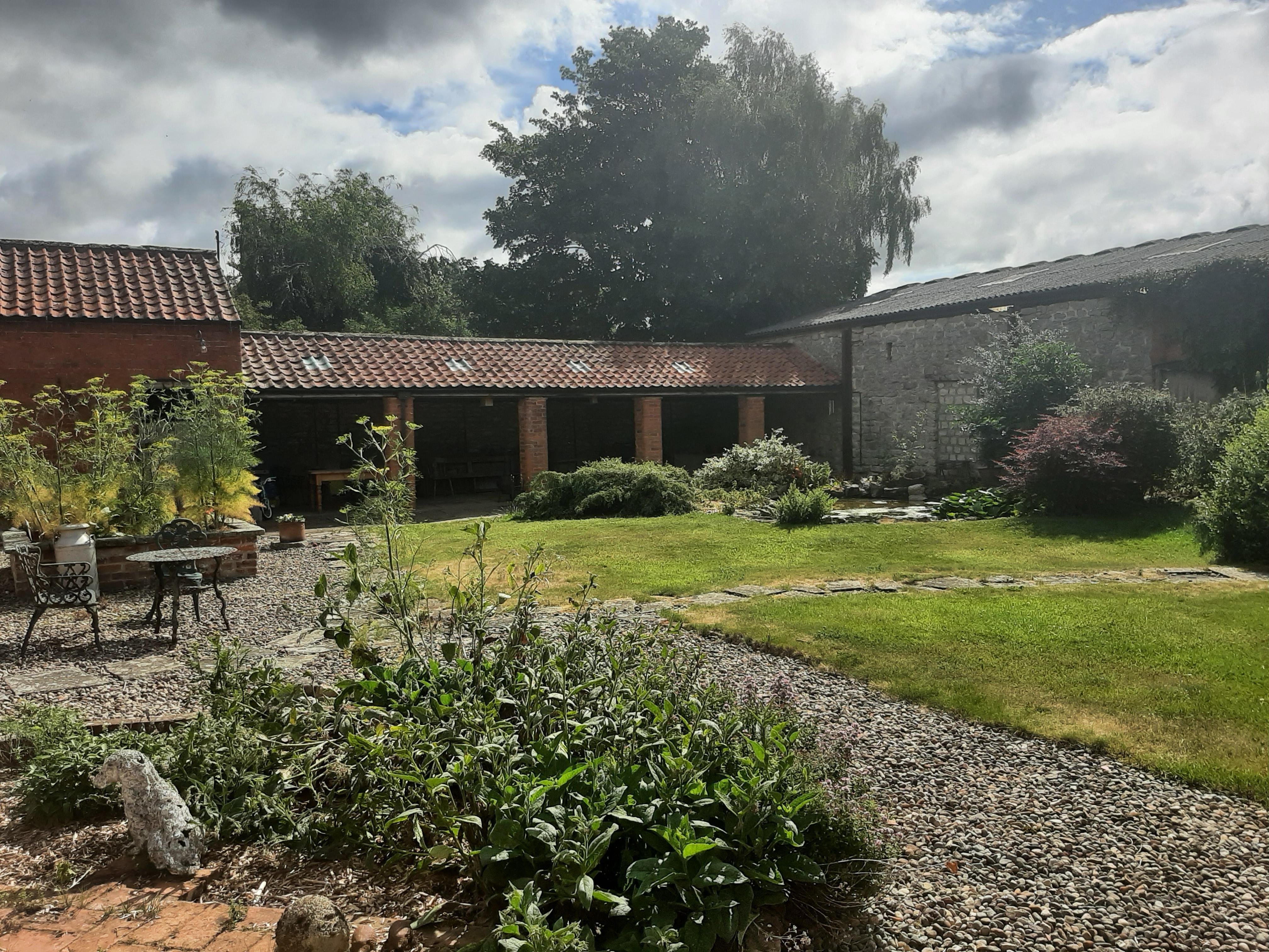 Shared courtyard with pond and nesting swallows 