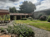 Shared courtyard with pond and nesting swallows