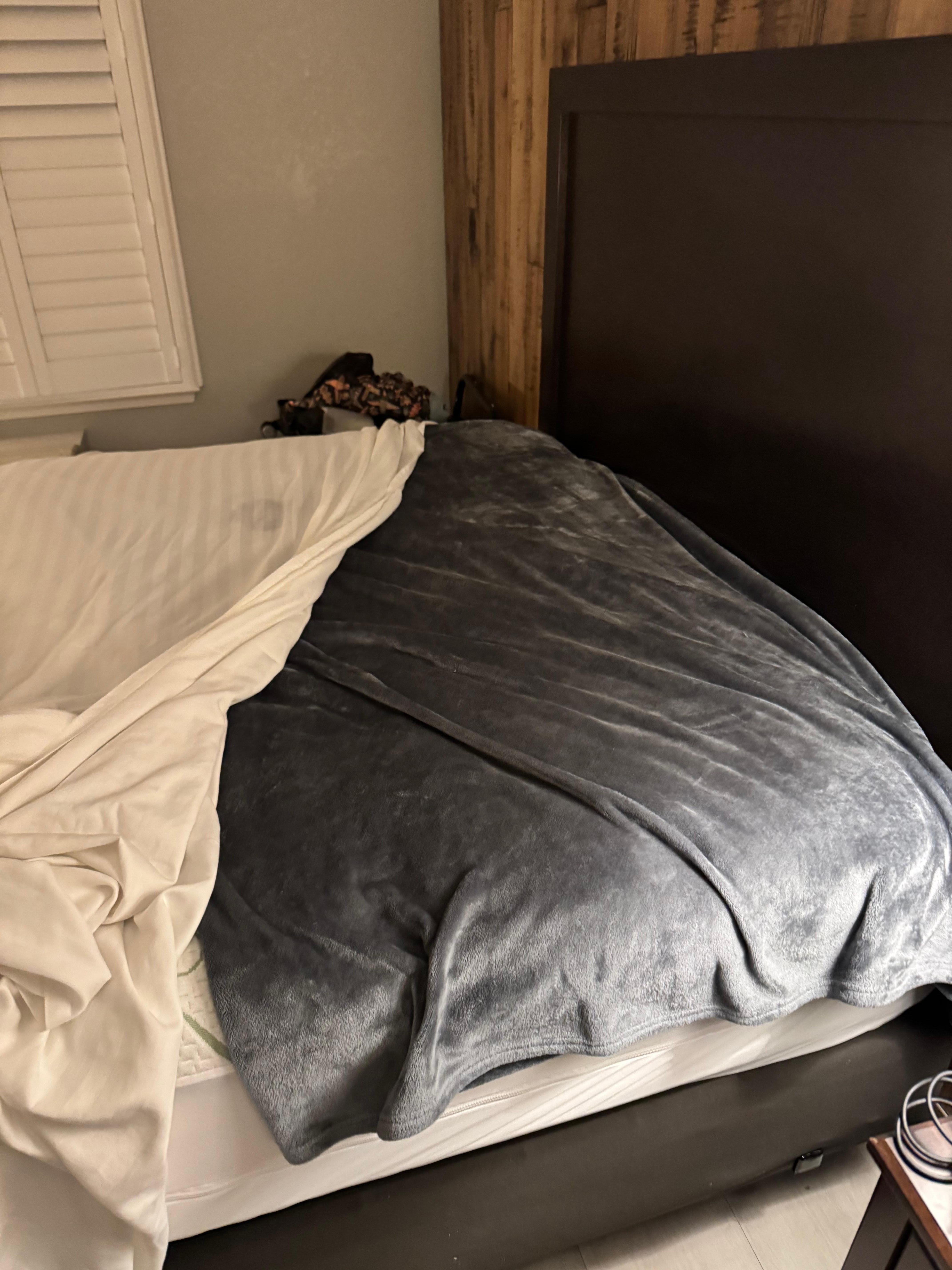 Blanket used to cover the vomit-contaminated area since no new mattress protector was provided.
