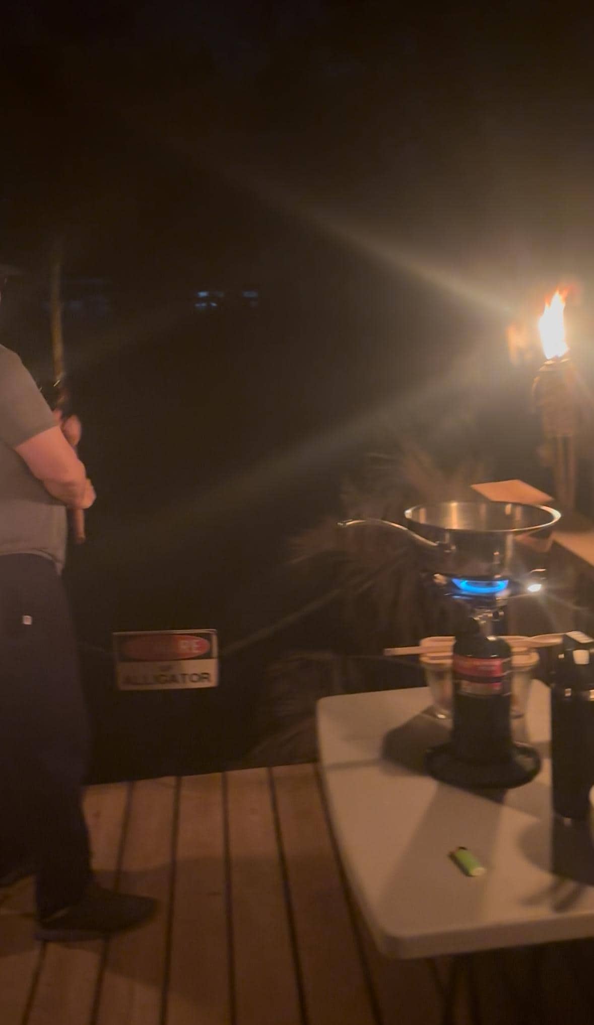 cooking dinner while night fishing by the tiki fires on the dock