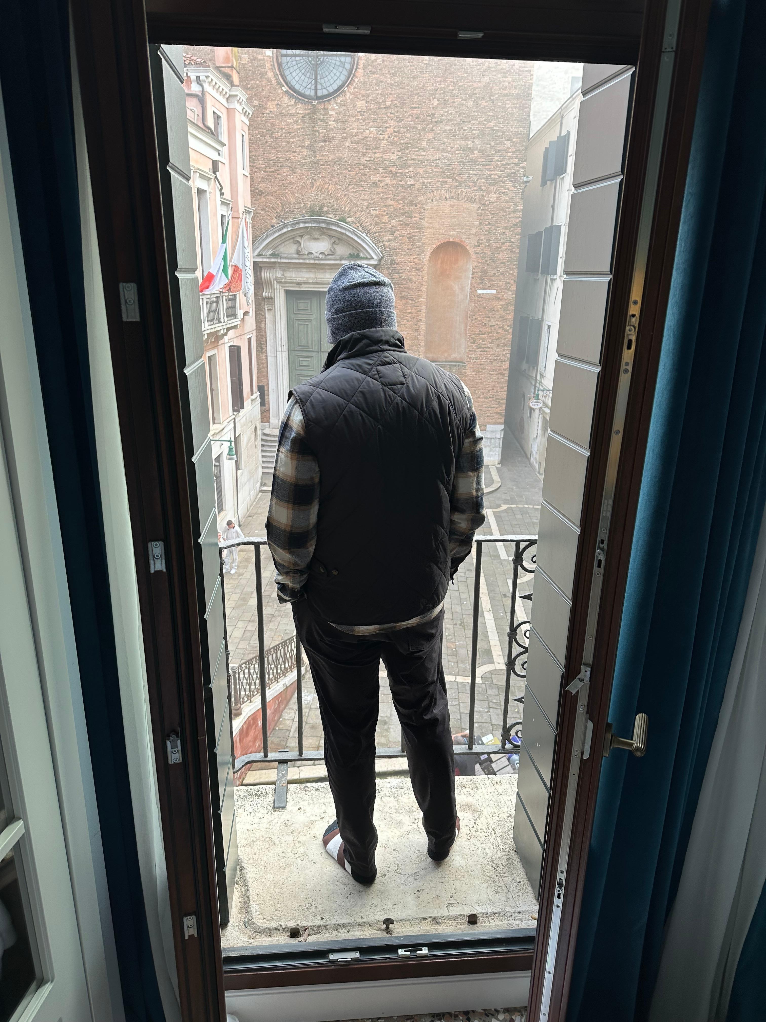 Husband enjoying the view from the balcony of our hotel.